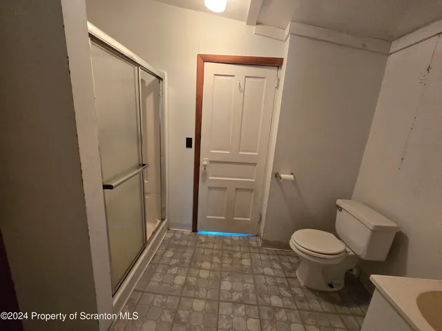 a bathroom with a toilet and a shower