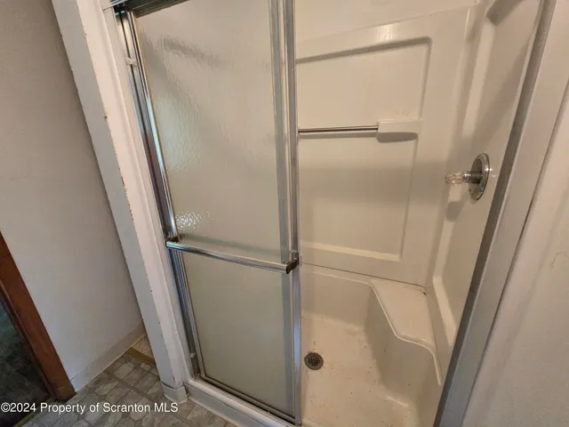 a bathroom with a glass door shower