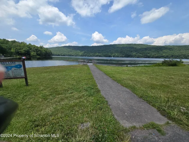 a view of a lake with houses in the back