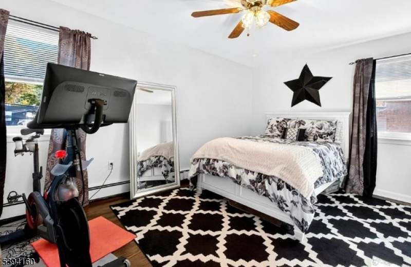 61 Star Lake Road, Unit 2 Bloomingdale, NJ 07403 - Photo 12 of 18 a bedroom with a bed and wooden floor