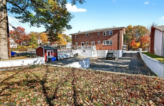 a view of a house with a yard next to a road