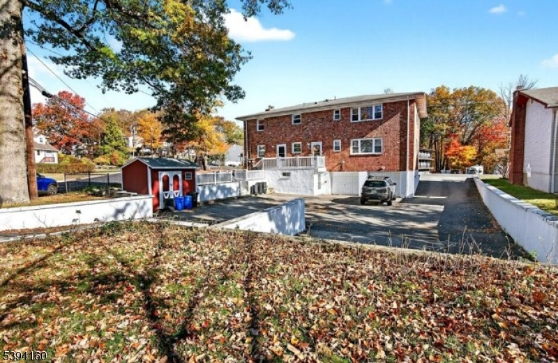 61 Star Lake Road, Unit 2 Bloomingdale, NJ 07403 - Photo 16 of 18 a view of a house with a yard next to a road