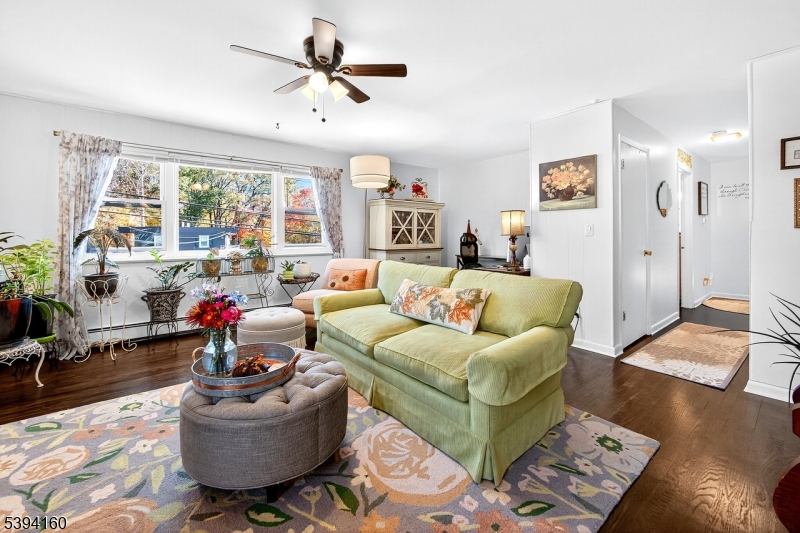 61 Star Lake Road, Unit 2 Bloomingdale, NJ 07403 - Photo 2 of 18 a living room with furniture and a large window