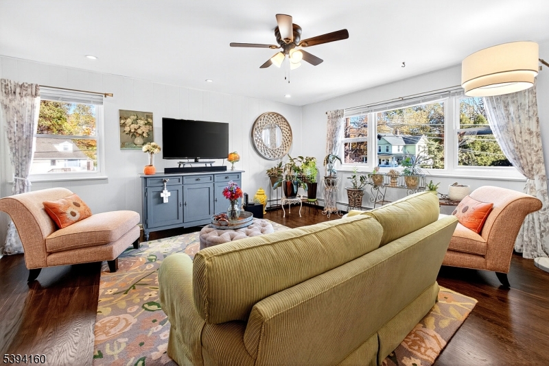 61 Star Lake Road, Unit 2 Bloomingdale, NJ 07403 - Photo 3 of 18 a living room with furniture a flat screen tv and a large window