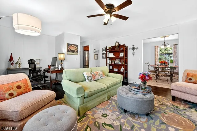 a living room with furniture and a book shelf