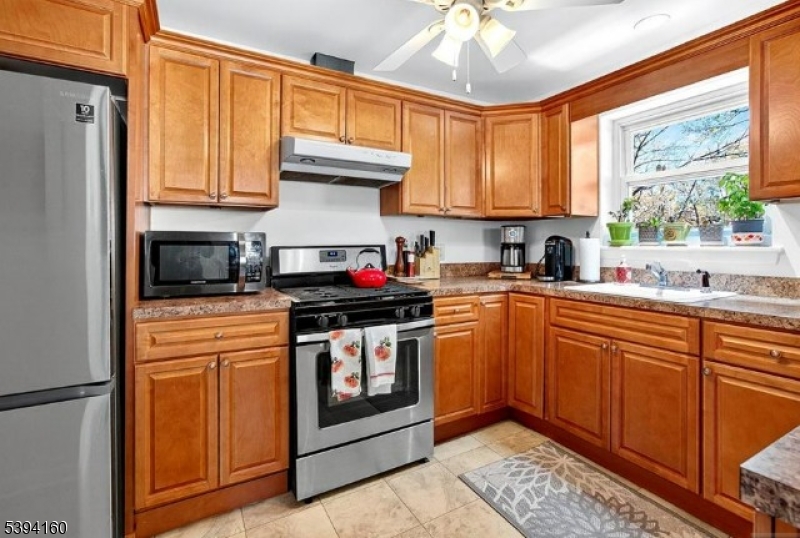 61 Star Lake Road, Unit 2 Bloomingdale, NJ 07403 - Photo 6 of 18 a kitchen with stainless steel appliances granite countertop a stove a sink dishwasher and a refrigerator