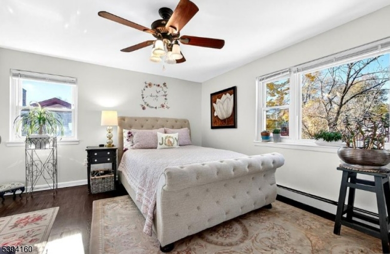 61 Star Lake Road, Unit 2 Bloomingdale, NJ 07403 - Photo 7 of 18 a bedroom with a bed and a chandelier