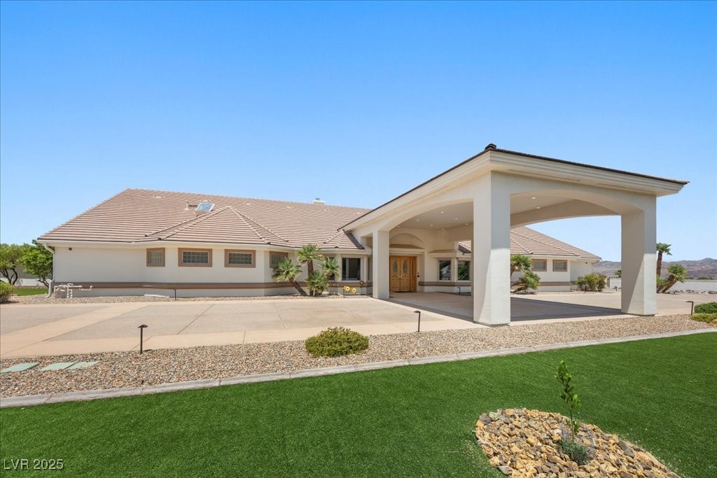 640 Quail Covey Road Henderson, NV 89002 - Photo 1 of 75 Front view of property featuring a lawn, stucco siding, and a tile roof