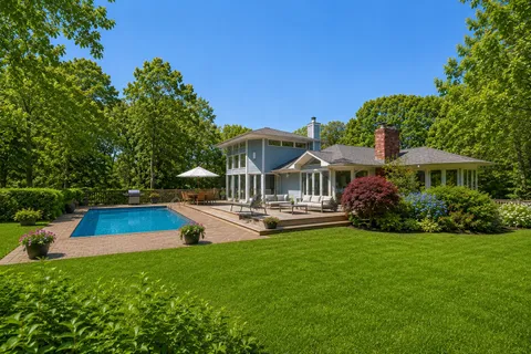 a view of a house with a yard porch and sitting area
