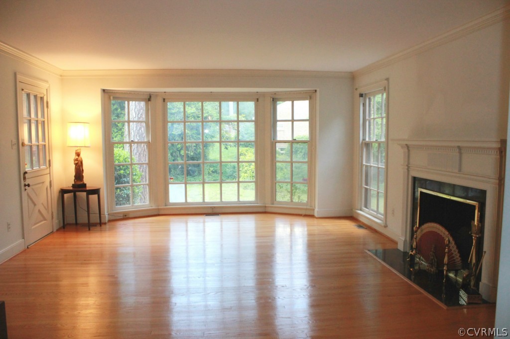 8007 Cameron Road Henrico, VA 23229 - Photo 3 of 24 a view of an empty room with exposed radiator and fireplace
