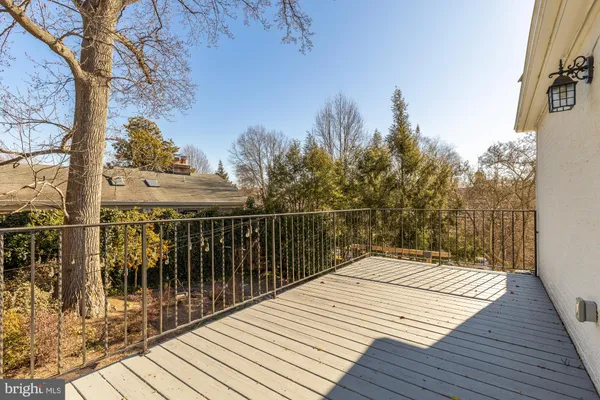 a view of balcony with wooden floor and fence