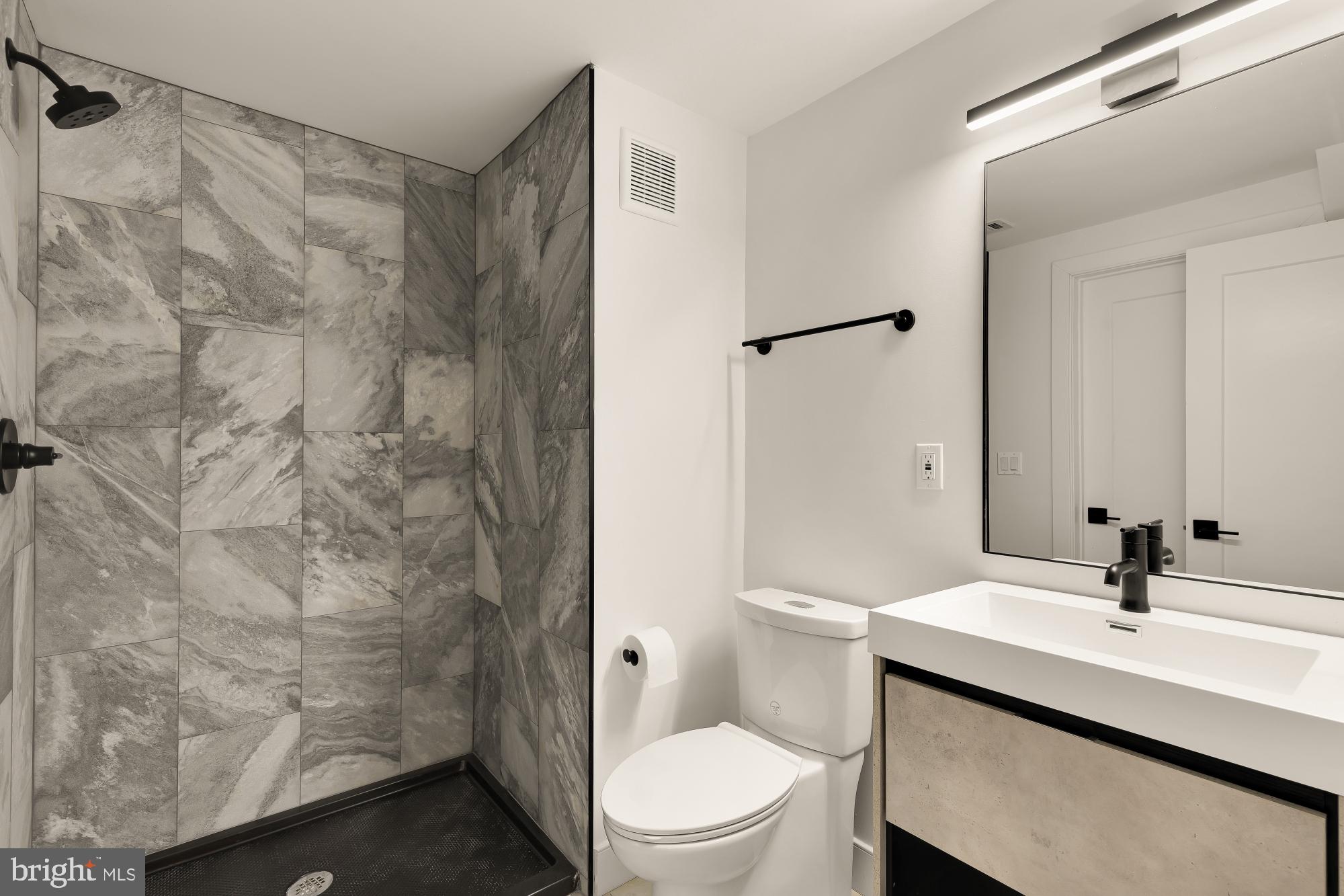 4105 17th Street Northwest Washington, DC 20011 - Photo 25 of 31 a bathroom with a sink a toilet and shower