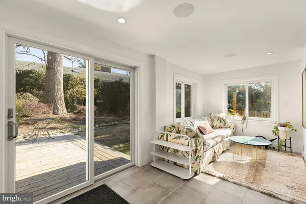 a living room with furniture and large windows