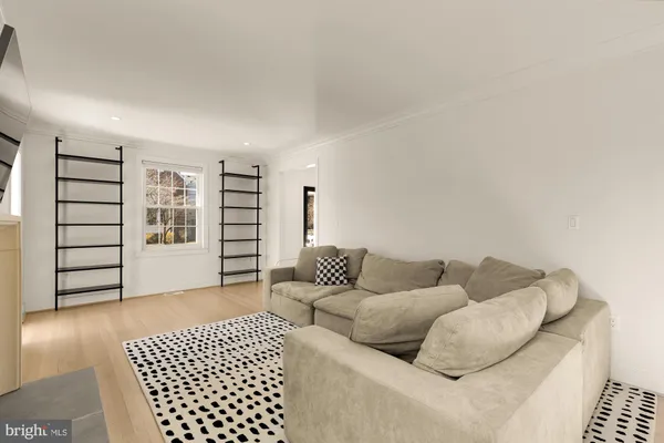 a living room with furniture and a walk in closet