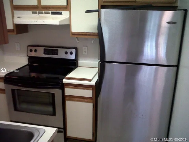 a white refrigerator freezer sitting inside of a kitchen
