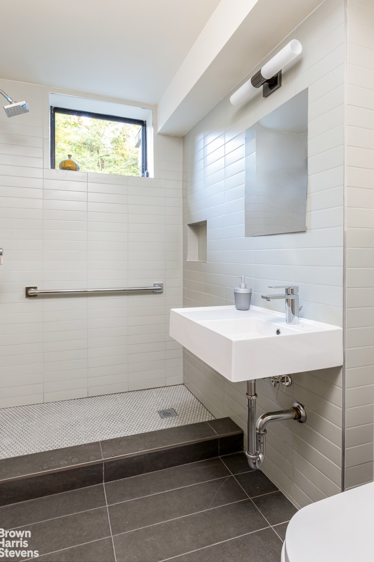 712 Ladd Road Bronx, NY 10471 - Photo 14 of 34 a bathroom with a sink and a mirror