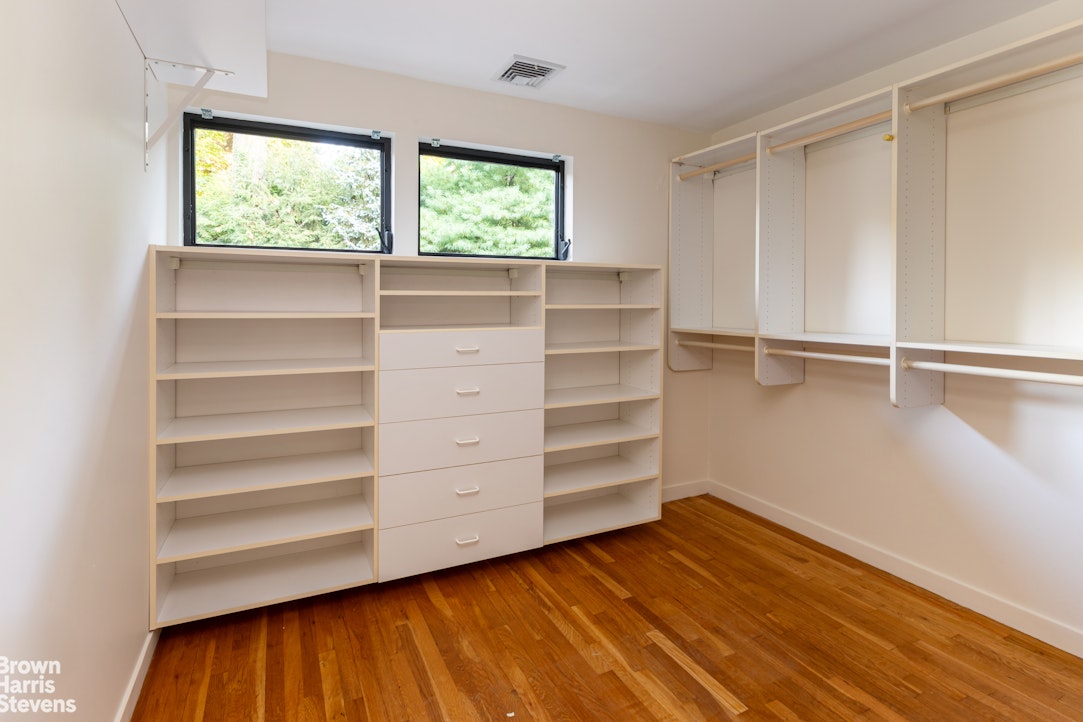 712 Ladd Road Bronx, NY 10471 - Photo 19 of 34 a view of an empty room with a window and wooden floor