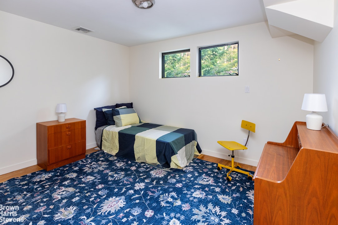 712 Ladd Road Bronx, NY 10471 - Photo 20 of 34 a bedroom with bed and a window