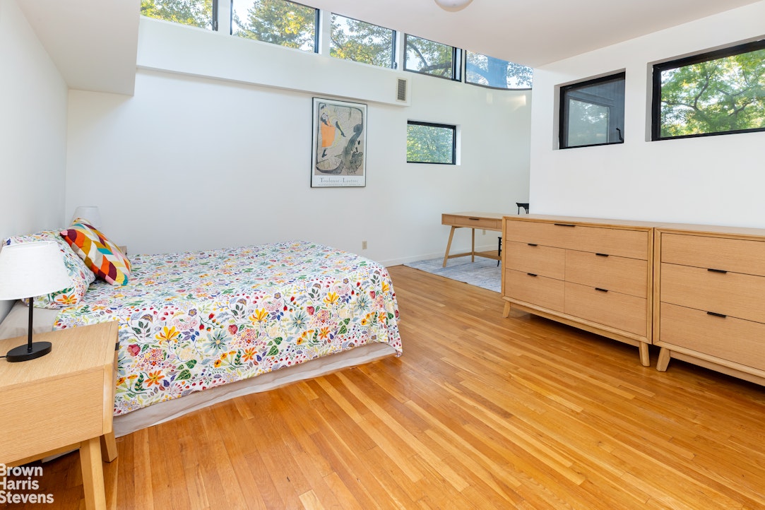 712 Ladd Road Bronx, NY 10471 - Photo 21 of 34 a bedroom with a bed and wooden floor