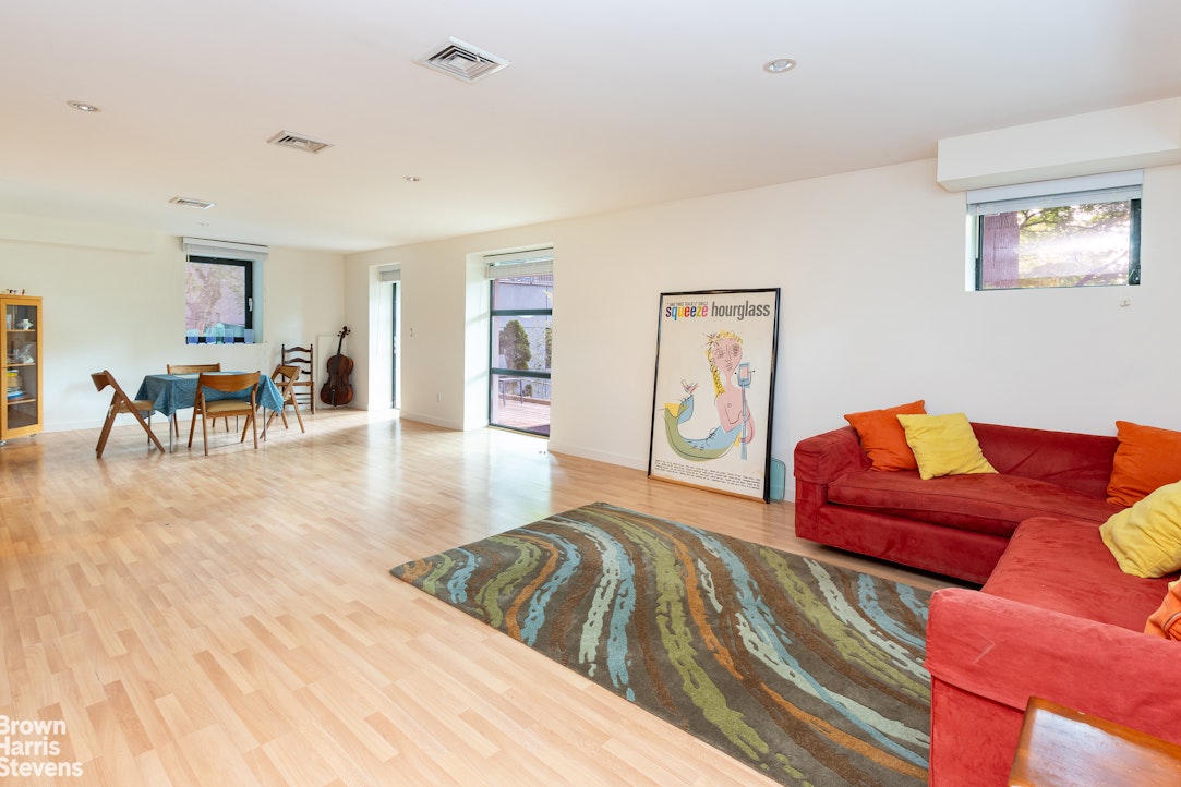 712 Ladd Road Bronx, NY 10471 - Photo 26 of 34 a living room with furniture and a wooden floor