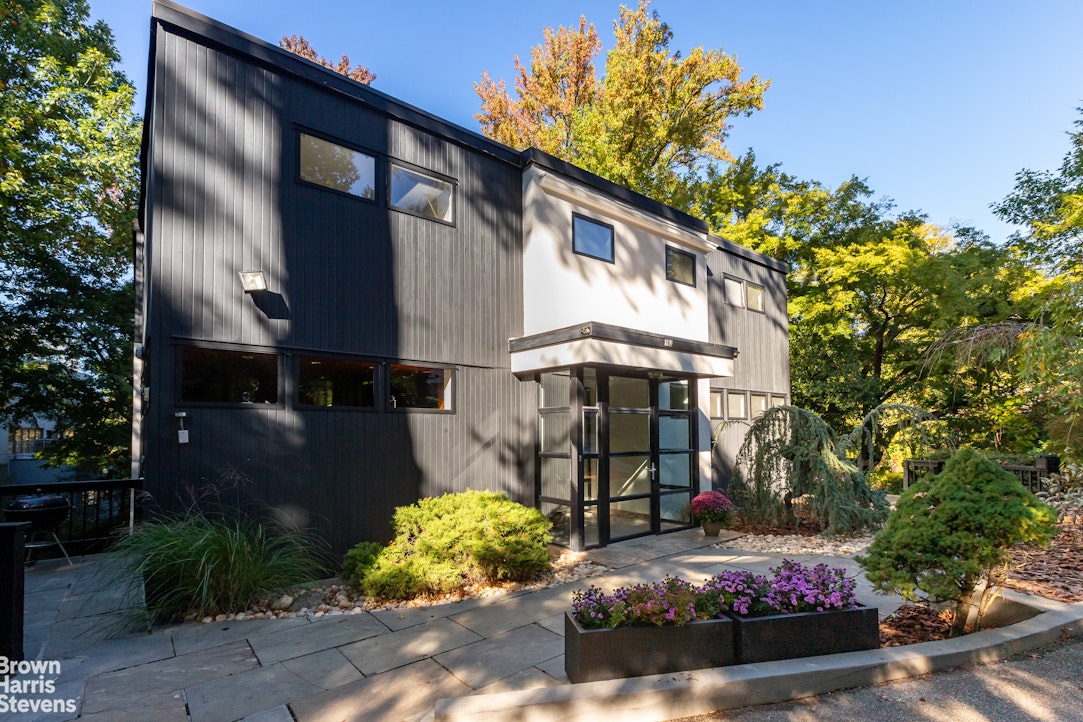 712 Ladd Road Bronx, NY 10471 - Photo 30 of 34 a front view of a house with garden