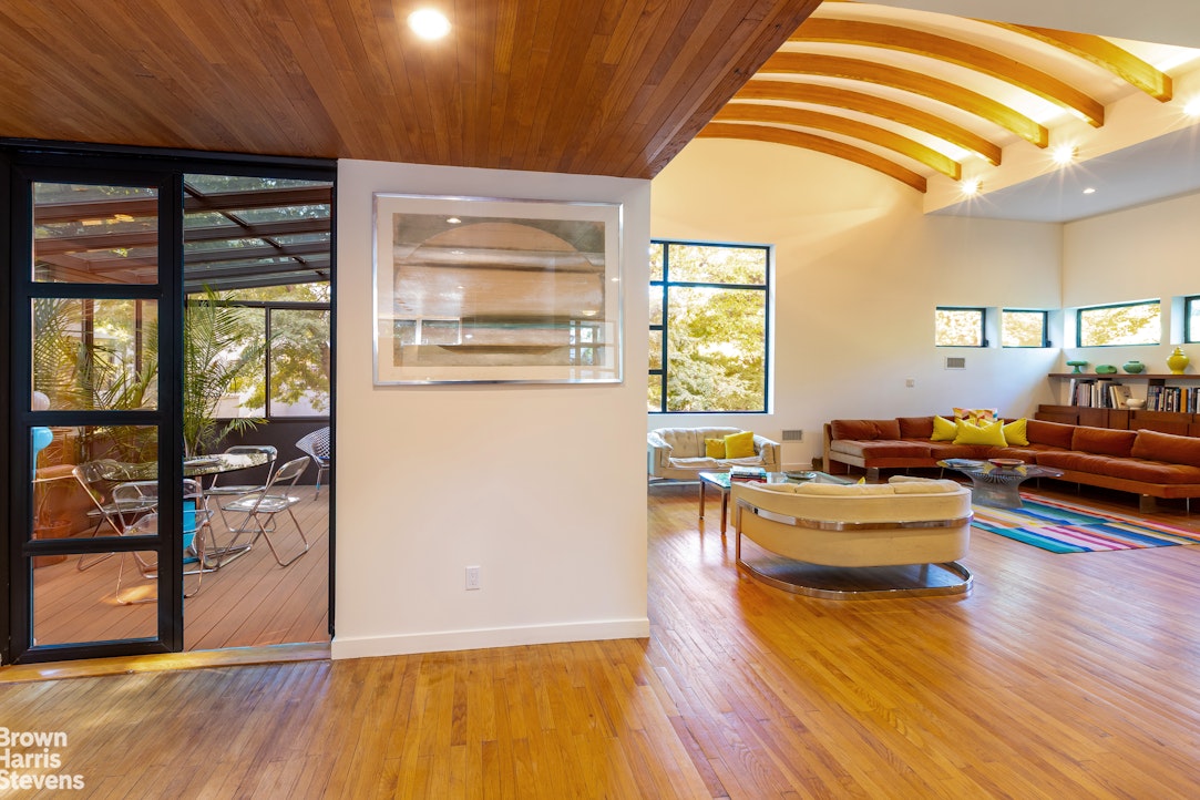 712 Ladd Road Bronx, NY 10471 - Photo 6 of 34 a living room with furniture and a table
