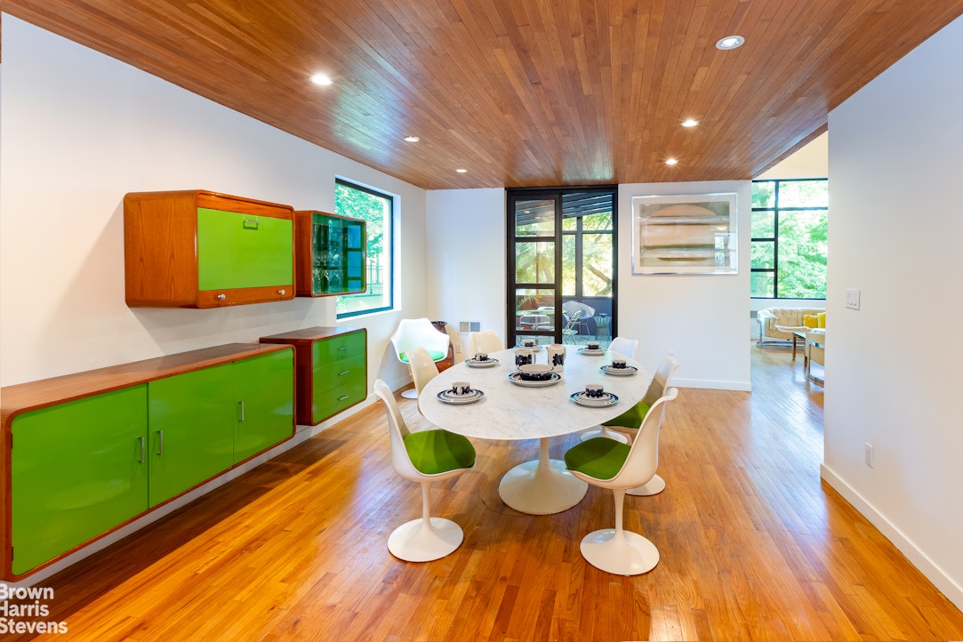 712 Ladd Road Bronx, NY 10471 - Photo 8 of 34 a view of a dining room with furniture and a wooden floor