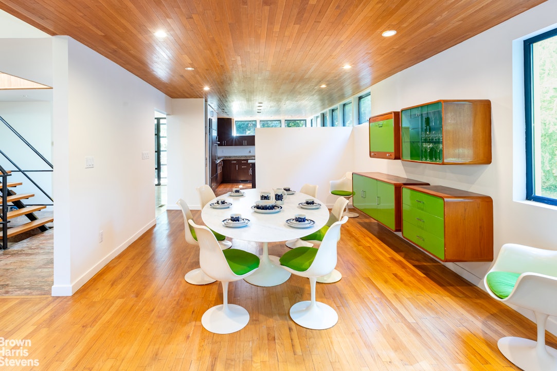 712 Ladd Road Bronx, NY 10471 - Photo 9 of 34 a dining room with furniture and a kitchen view