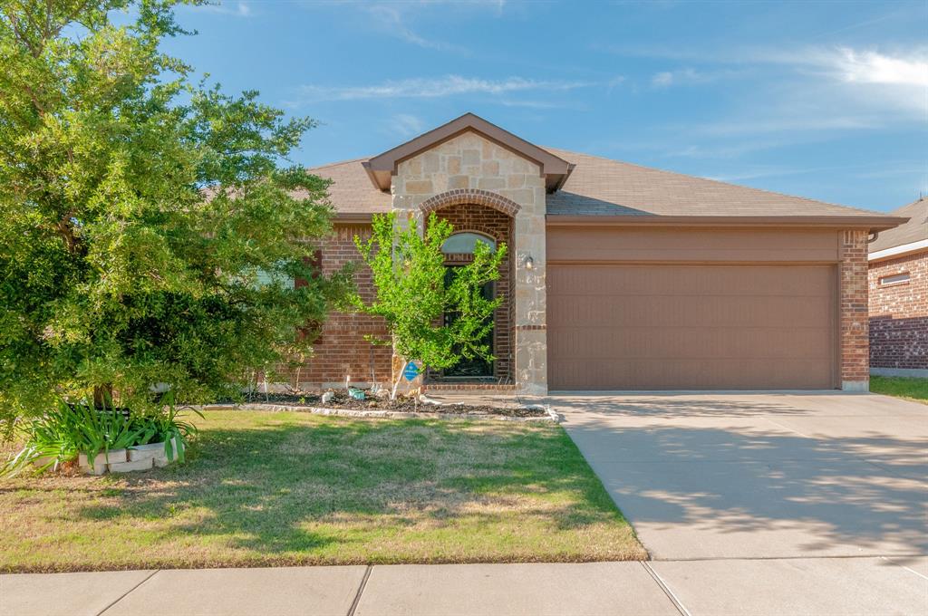 1936 Kachina Lodge Road Fort Worth, TX 76131 - Photo 1 of 1 a front view of a house with a yard