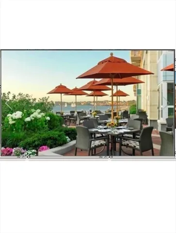 a view of patio with a table and chairs under an umbrella