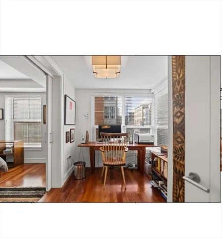 a living room with furniture and a dining table with kitchen view