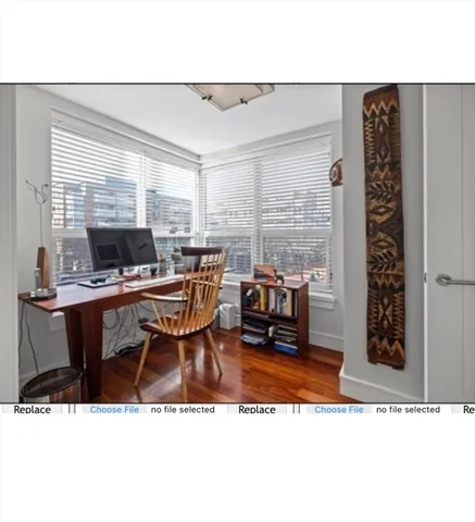 a living room with furniture a window and a flat screen tv