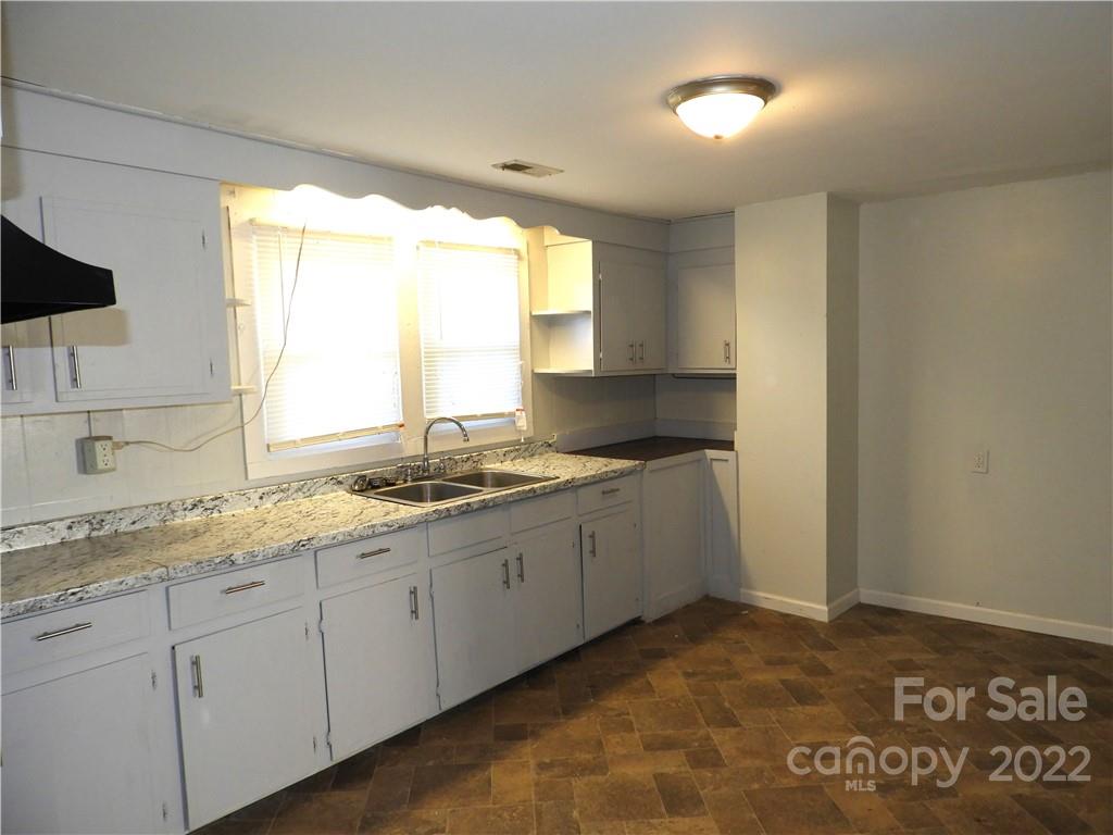529 Jacktown Road Marion, NC 28752 - Photo 7 of 14 a kitchen with granite countertop a sink and a window