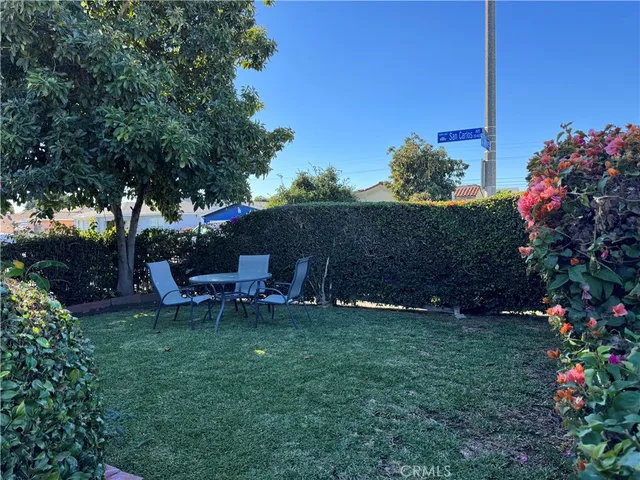 a view of a chairs and table in backyard of the house