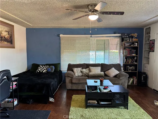 a living room with furniture and a bookshelf