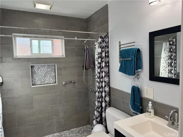a bathroom with a toilet sink and shower