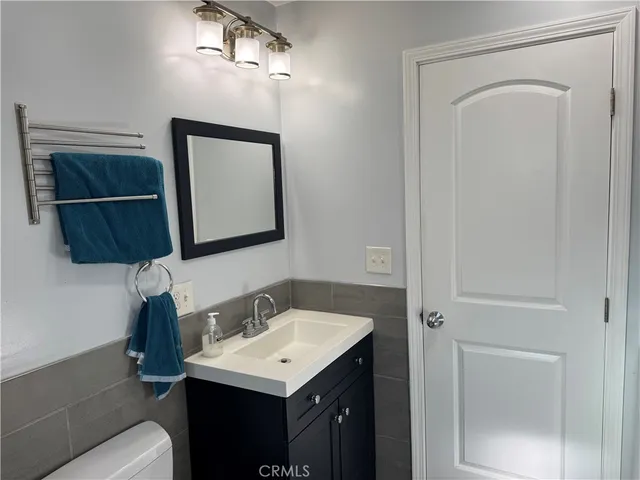 a bathroom with a sink vanity and mirror