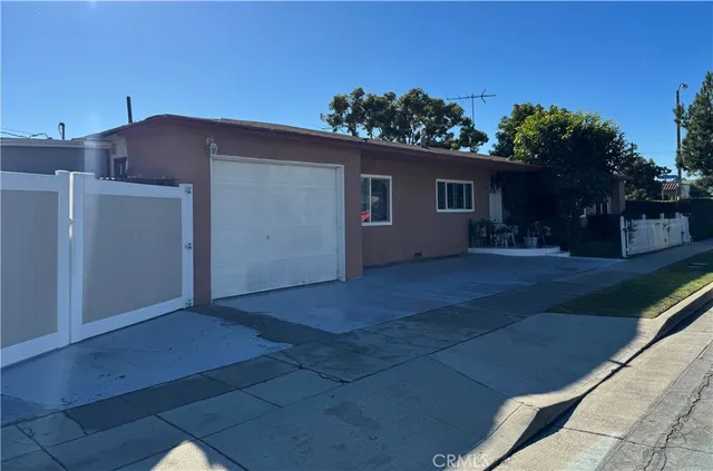 a view of a house with a yard and potted plants