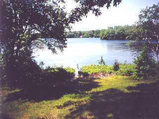 Undisclosed Address Centerville, MA 02632 - Photo 2 of 2 a view of a lake with mountain in front of it