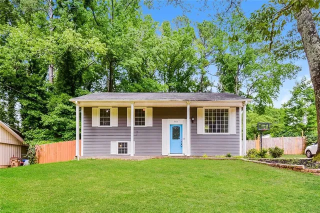 a front view of a house with a garden