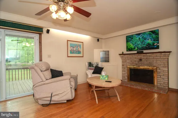 a living room with furniture fireplace and window