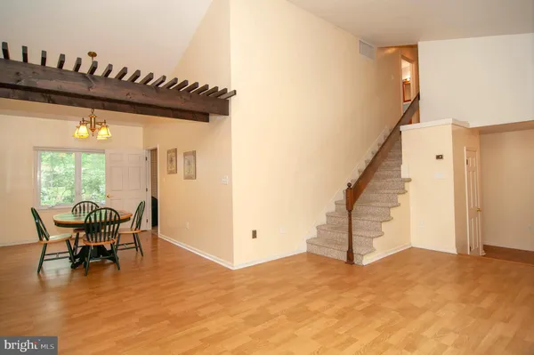a view of a livingroom with furniture and staircase