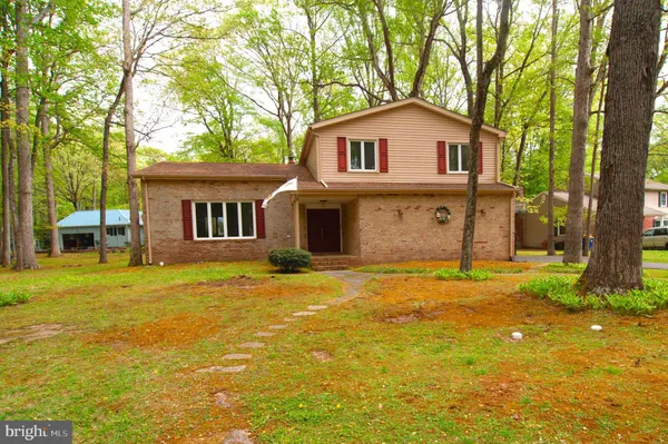 a house view with swimming pool in front of it