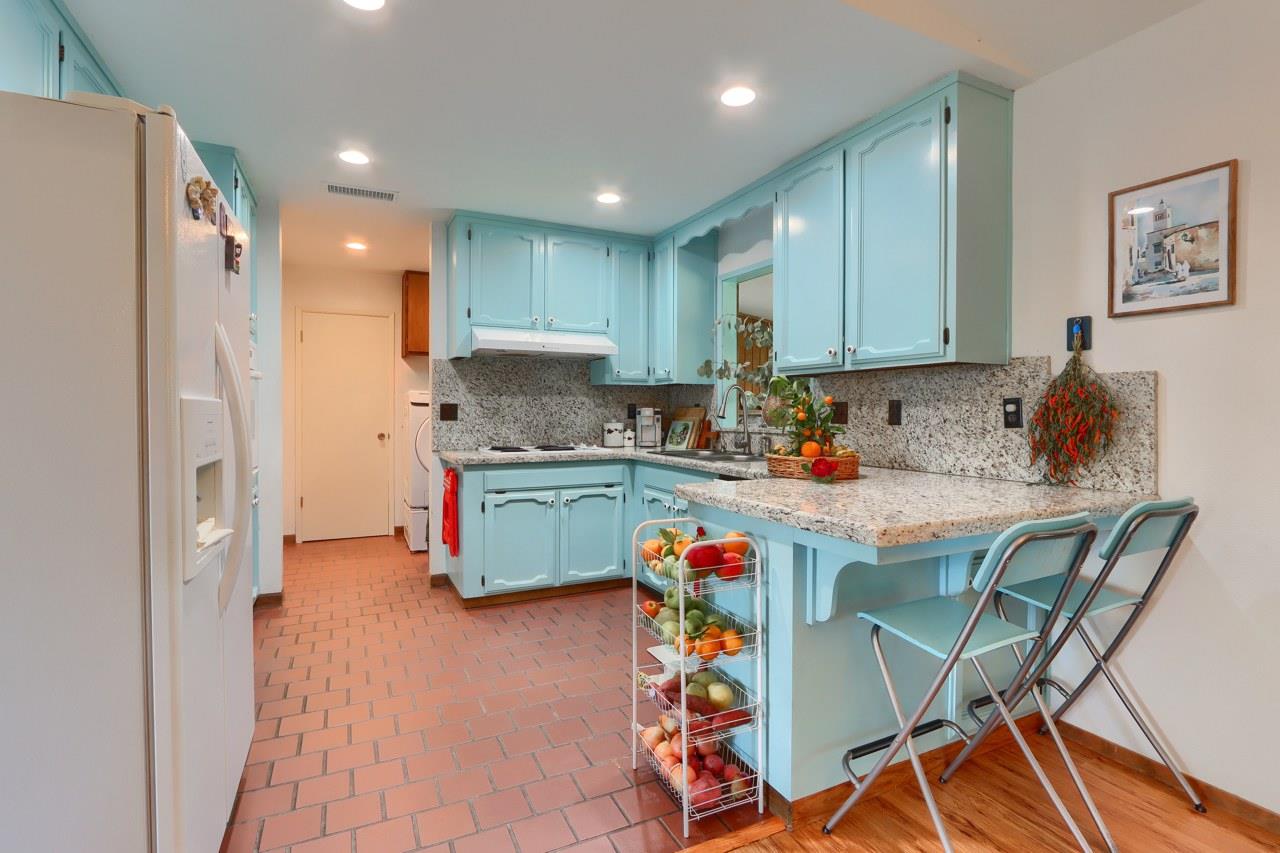 44800 Ahwahnee Acres Road Ahwahnee, CA 93601 - Photo 12 of 77 a kitchen with a dining table chairs refrigerator and cabinets