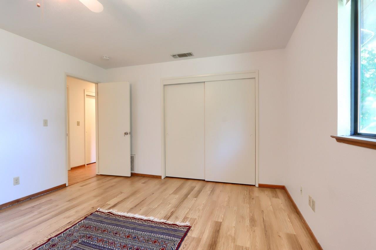 44800 Ahwahnee Acres Road Ahwahnee, CA 93601 - Photo 21 of 77 an empty room with wooden floor and windows