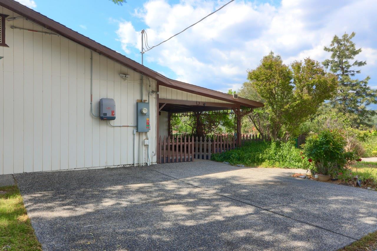 44800 Ahwahnee Acres Road Ahwahnee, CA 93601 - Photo 50 of 77 a view of a backyard with large trees and wooden fence