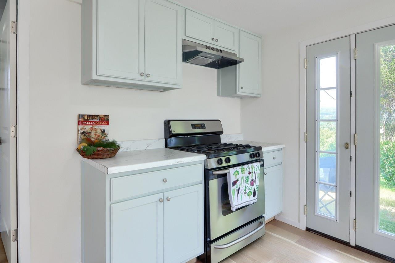 44800 Ahwahnee Acres Road Ahwahnee, CA 93601 - Photo 60 of 77 a kitchen with stainless steel appliances granite countertop a stove a refrigerator and a white cabinets