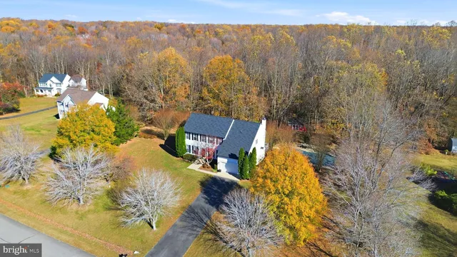 a view of a swimming pool with a table and chairs under an umbrella