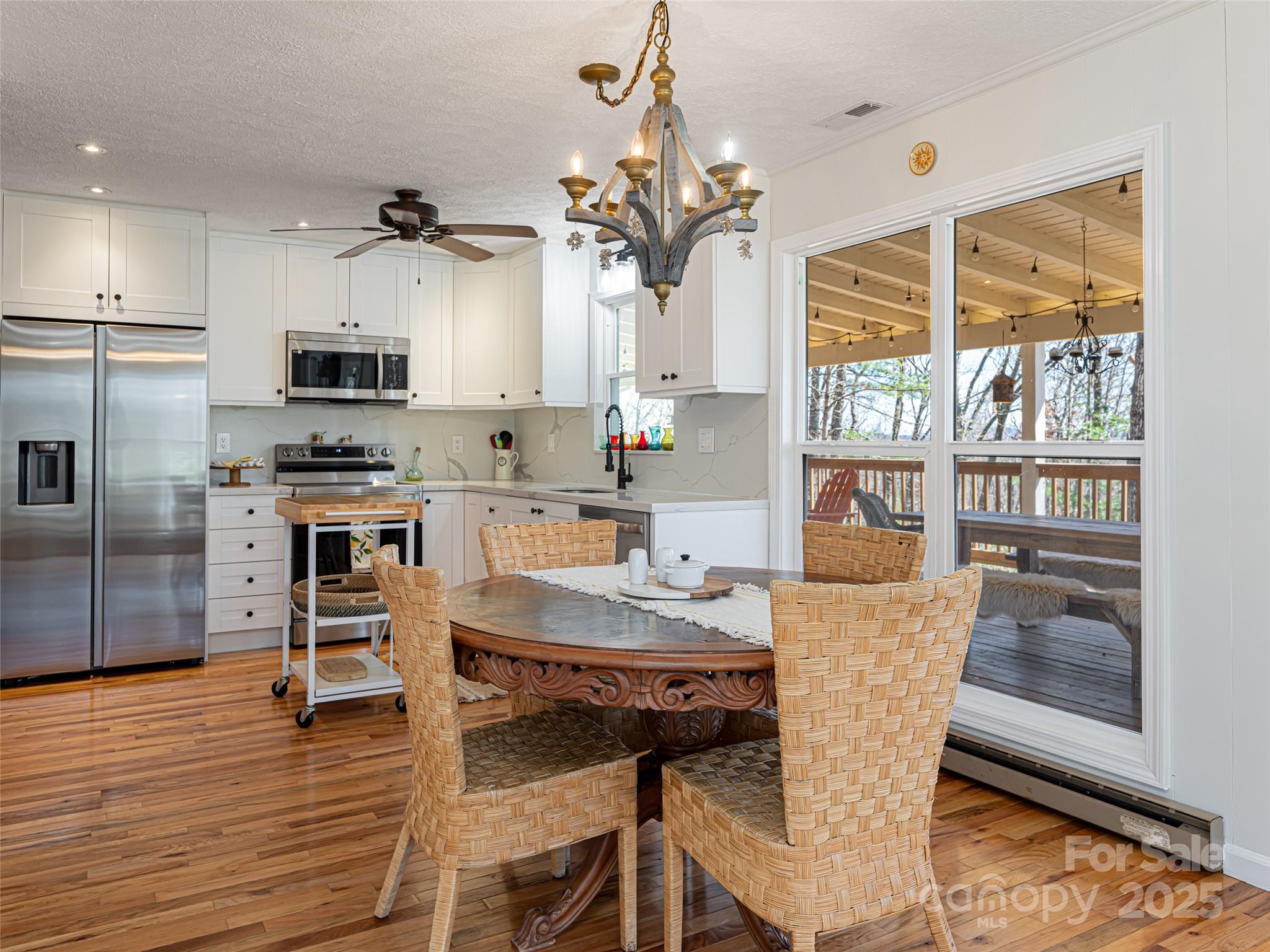 75 Deep Woods Road Mills River, NC 28759 - Photo 12 of 48 a view of a dining room with furniture and wooden floor