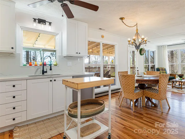 a kitchen with sink cabinets and dining table